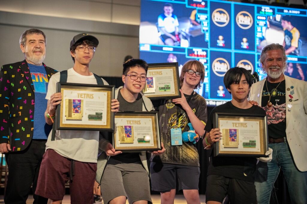 PixelAndy, Fractal, Blue Scuti, and Alex T poses for a photo with their Game Crash certificate.